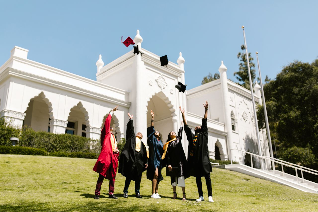 Crafting Captivating Headlines: Your awesome post title goes here Group of graduates celebrate by tossing caps outside a historic building